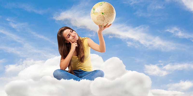Young student woman holding a globe and sitting on a cloud