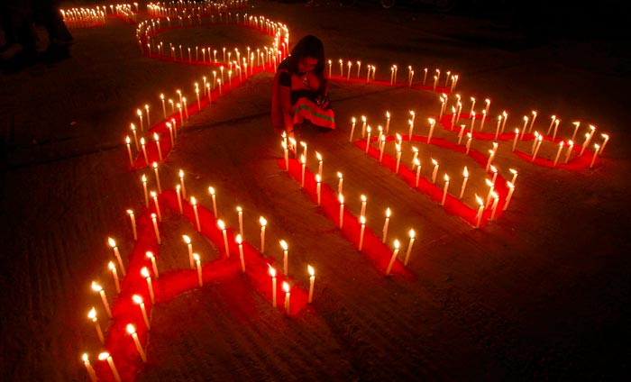Candles lit up in the shape of the AIDS symbol