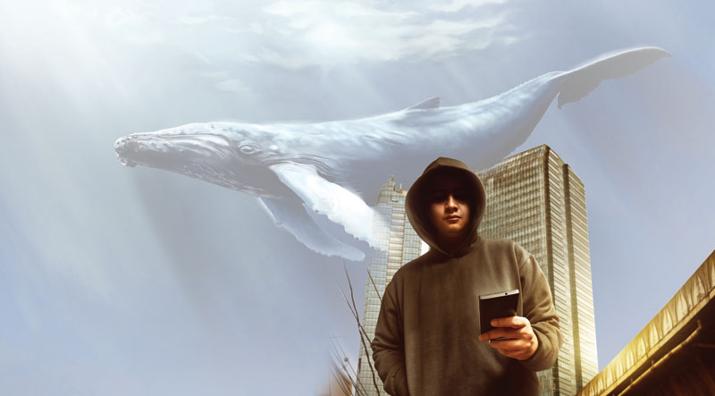 Teen playing mobile game against a backdrop of a blue whale