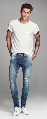 Male model wearing distressed denims and white tee shirt