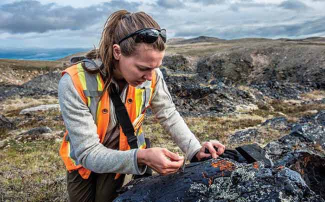 Female geologist examining rock samples