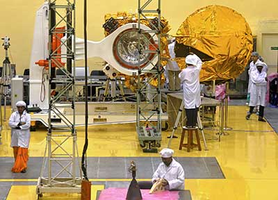 Scientists and engineers work on a Mars orbiter vehicle at ISRO’s satellite center in Bangalore