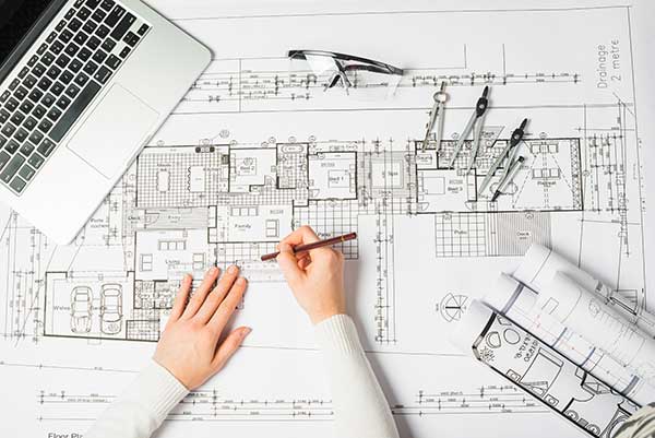 Architect using drawing tools on planning board