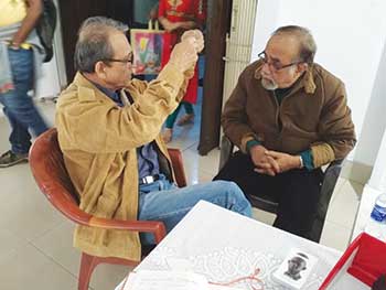 Manoj engaged in an intense discussion with noted artist Aditya Basak