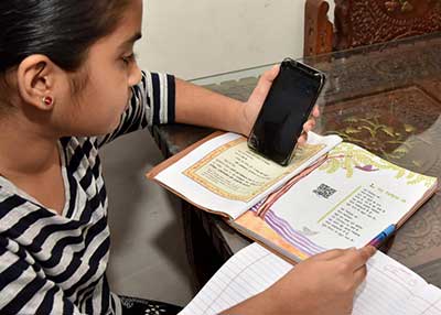 Girl using smartphone to do her studies