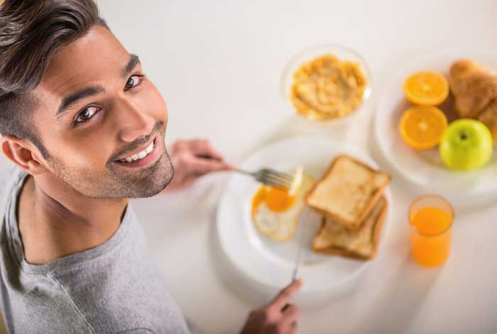 Young man eating a healthy breakfast