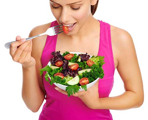 Young woman eating a healthy salad