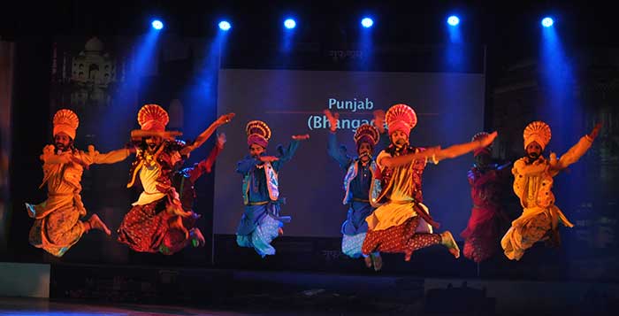 Men performing the Bhangra Dance on stage