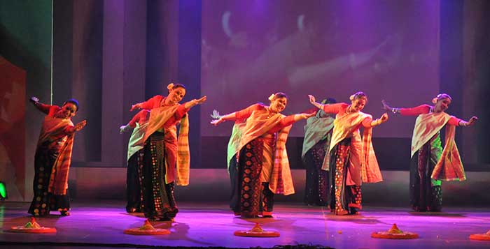 Women performing Bihu Dance on stage