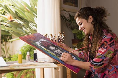 Young woman smiling and painting