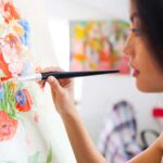 Female artist painting on a canvas
