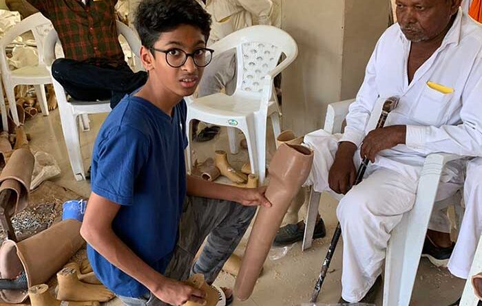 Veer Agrawal presenting a Jaipur Foot to a disabled man