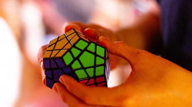 Hands solving Rubik's Cube