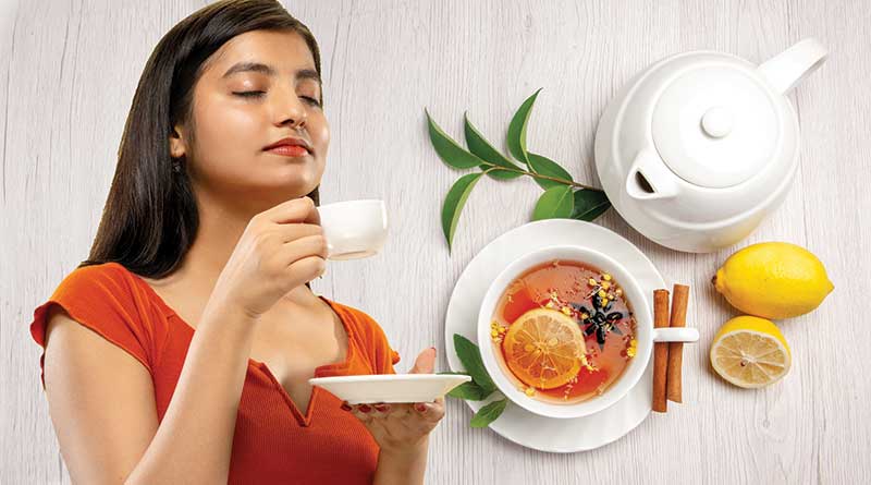 Young woman drinking a cup of herbal Ayurvedic tea