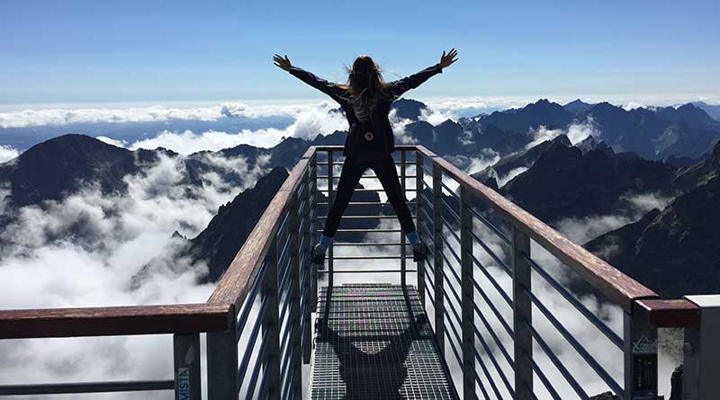 Happy young woman on a mountaintop