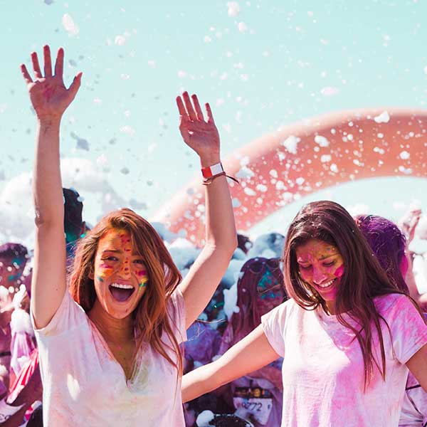 Happy girls playing Holi with colour on their faces