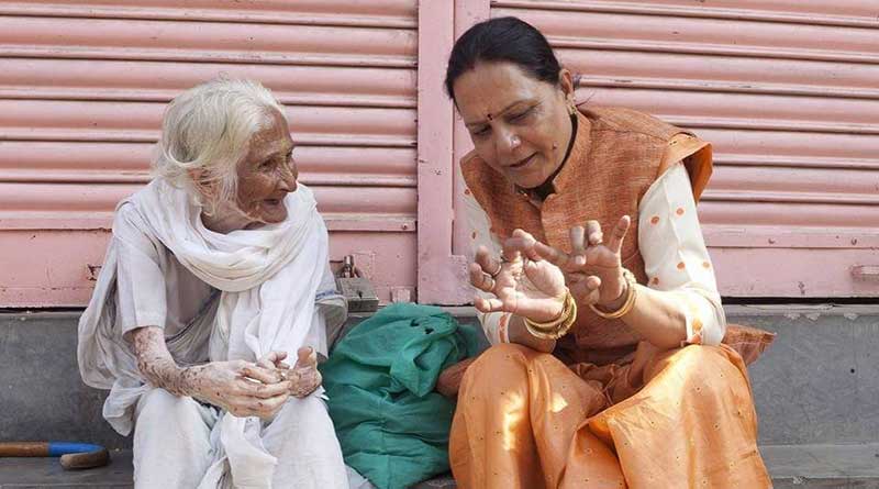 Laxmi Gautam talking to an old widow